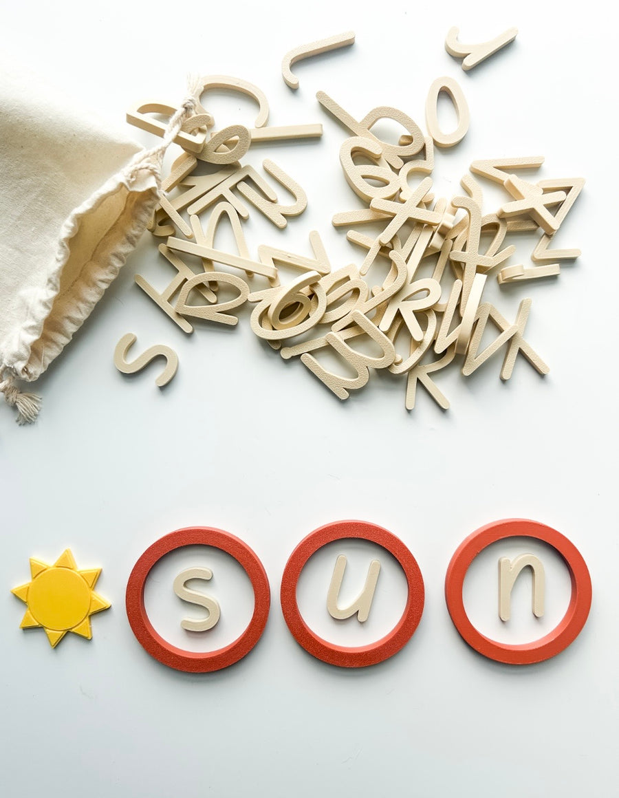 Wooden letters spelling sun inside three terracotta Learning Circles